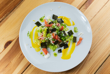 Delicious rice salad with lettuce, tomato, escarole and seaweed. Gourmet salad with natural products.