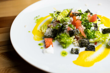 Delicious rice salad with lettuce, tomato, escarole and seaweed. Gourmet salad with natural products.