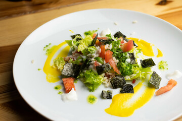 Delicious rice salad with lettuce, tomato, escarole and seaweed. Gourmet salad with natural products.