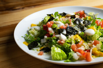 Delicious rice salad with lettuce, tomato, escarole and seaweed. Gourmet salad with natural products.