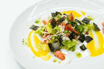 Delicious rice salad with lettuce, tomato, escarole and seaweed. Gourmet salad with natural products.