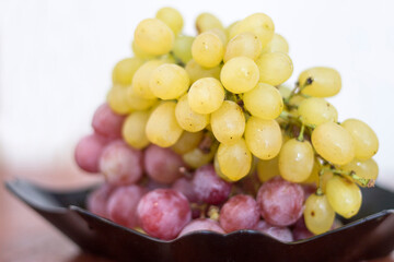 Red and White wine bunch of grapes in the black plate