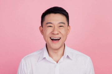 Photo of funny positive cheerful man laugh have fun isolated pink color background