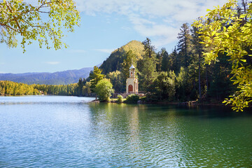 Orthodox Chapel of the Holy Prophet Solomon on the shore of a Emerald Lake among the mountains and forests. 