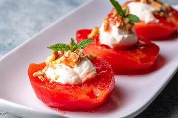 Traditional Turkish style quince dessert. The quince is cooked until soft, sherbet is poured on it, and served with cream and walnuts. It is one of the most popular Turkish desserts.(Ayva Tatlisi)