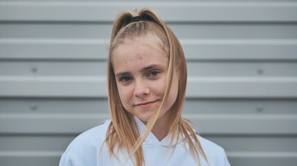 Portrait of a blonde teenage girl. Face close-up.