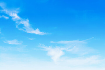 The blue sky is tinged with white clouds in the air on a bright summer day.