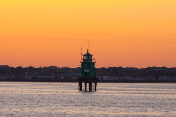 Port Beacon in Dublin Port during sunset, orange sky