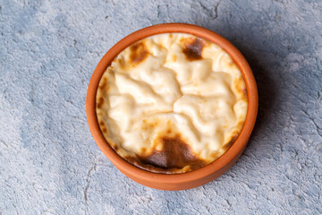Baked rice pudding turkish milky dessert sutlac in earthenware casserole with hazelnuts