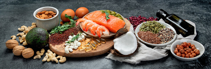 Assortment of omega 3 best sources on dark background.
