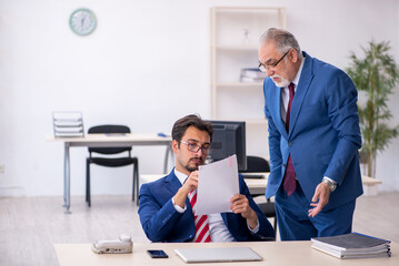 Two male colleagues working in the office