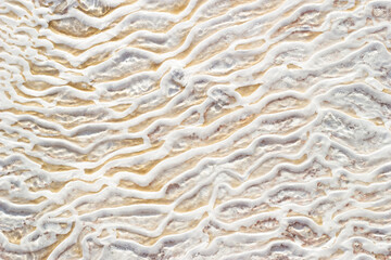 Textural background of asymmetric drawing. Natural texture of travertine Pamukkale. Close-up