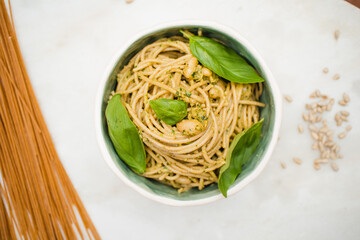 spaghetti with pesto sauce in a handmade pottery bowl on a marble surface dish cuisine plated delicious dish vegan meal vegan recipe
