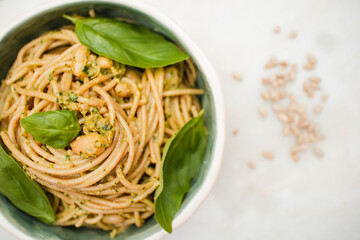 spaghetti with pesto sauce in a handmade pottery bowl on a marble surface dish cuisine plated delicious dish vegan meal vegan recipe