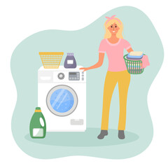 Happy woman with a basket of laundry is standing near the washing machine. Laundry time. Woman housewife.
