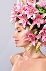 Beautiful woman with flowers in her hair. Bouquet of Beautiful Flowers. Hairstyle with flowers. Nature Hairstyle.