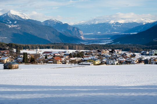Snow covered alpine mountain village with view on Telfs, Wildermieming, Tirol, Austria