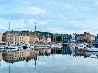 Honfleur harbour in Normandy, France. Color houses and their reflection in the river