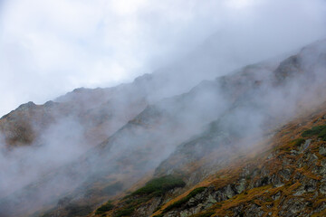 Landscape with mountain ridges in the fog