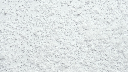 Coarse kitchen salt crystals scattered on a white background