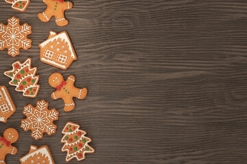 Gingerbread man, house, snowflake, Christmas tree on a wooden background, 3d render