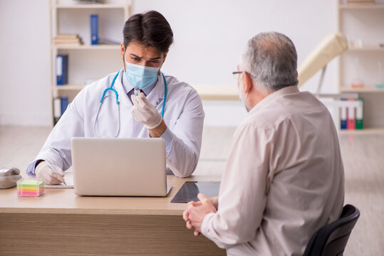 Old male patient visiting young male doctor in vaccination conce