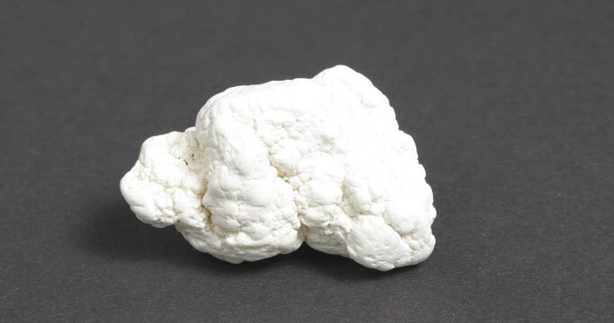 Magnesite on a dark background. It is used in industry, lithotherapy, jewelry.