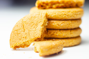 Fototapeta na wymiar Close up on a stack of cinnamon oat cookies on a white background