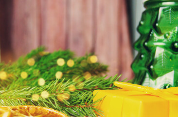 New Year's Eve. Retro style clock with christmas decorations and gifts on brown wooden background. Last moments before Christmas or New Year