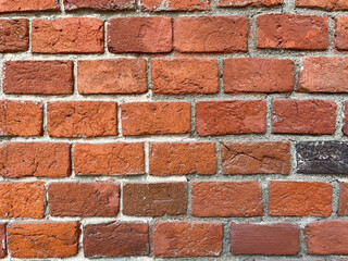 Brick red wall. Background of a old brick house.