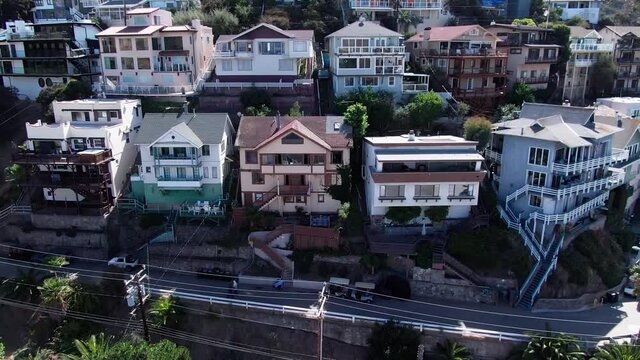 Slowly trucking and panning view of nice homes on a hillside on Catalina Island.