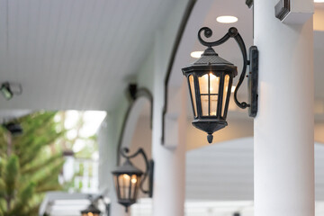 black vintage lamp on white concrete pole for house decoration.