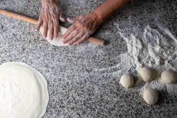Turkish style making bread with a rolling pin, yeast dough (Turkish name; hamur acmak)