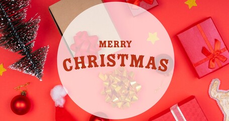 Composition of merry christmas text over christmas decorations and presents