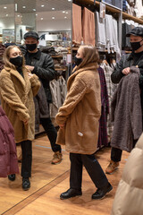 Black friday pandemic concept. Young couple in black masks at the mall