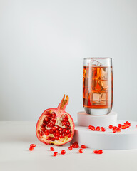 fresh organic pomegranate on white marble background, pomegranate juice
