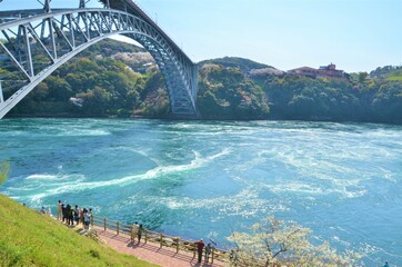 Huge light blue bridge and big sea