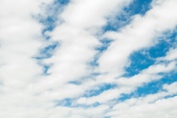 Beautiful blue sky with long longitudinal white clouds.