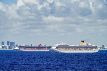 Modern Carnival and Costa cruiseships cruise ship liners at sea with Miami South Beach skyline in...