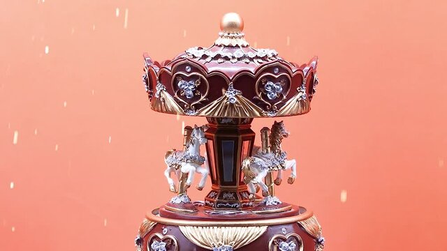 toy carousel music box with orange background and white horses , while snow falls with sparkles, slow motion,