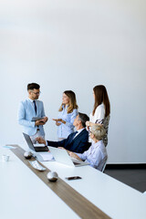 View at group of business people working together and preparing new project on a meeting in office