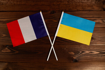 Flag of France and flag of Ukraine crossed with each other. The image illustrates the relationship between countries. Photography for video news on TV and articles on the Internet and media. - Powered by Adobe