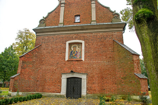 General view and architectural details close up of the belfry and the Catholic church of Saint Stanislaus the Bishop and Our Lady of the Rosary from 1507 in the city of Drobin in Masovia, Poland.