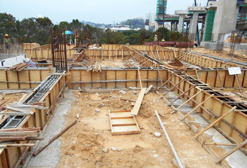 Fototapeta na wymiar KUALA LUMPUR, MALAYSIA -MARCH 29, 2021: Building ground beam under construction at the site using timber plywood as the formwork. The concrete was reinforced by the steel reinforcement bar 