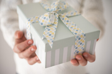 Photo of beautiful gift box in boy's hands at new year holidays or birthday celebration