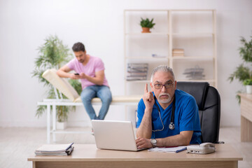 Young male patient visiting old male doctor