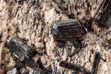 Macro mineral stone Schorl, Black Tourmaline on the feldspar on a white background