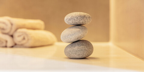 Fototapeta na wymiar Zen stones, smooth pebbles pyramid stacked balance, spa interior background.