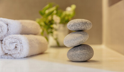Fototapeta na wymiar Zen stones, smooth pebbles pyramid stacked balance, wellness interior background.