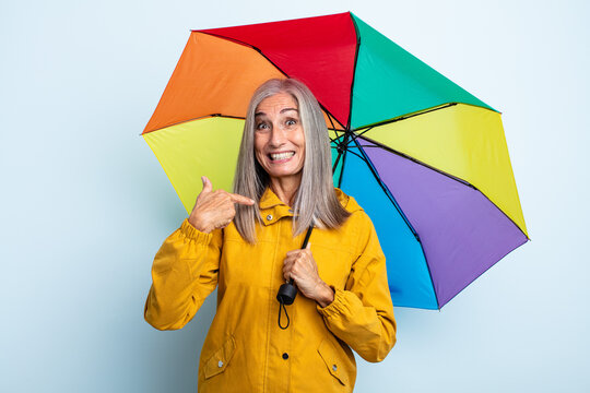 Middle Age Gray Hair Woman Feeling Happy And Pointing To Self With An Excited. Umbrella And Rain Concept